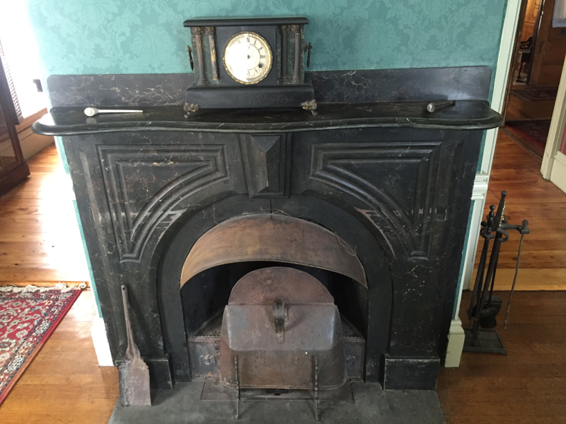 Coal burner in the sitting room. The original furnace was also present, and burned coal.